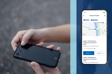 Eine Hand hält ein Smartphone mit kaputtem Display