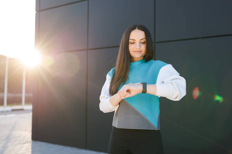 Eine Frau schaut auf ihre Smartwatch. 