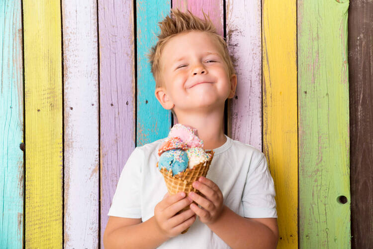 Kind freut mit Eis in der Hand