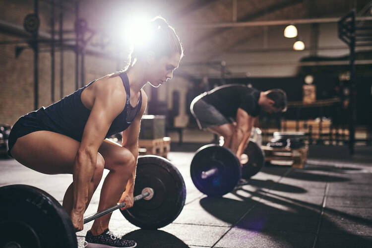 Mann und Frau trainieren Kreuzheben im Fitnessstudio