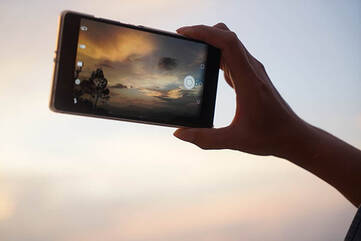 Smartphone gehalten in einer Handy nimmt Foto vom Himmel auf
