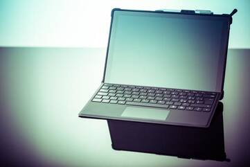 Laptop steht auf schwarzem Tisch