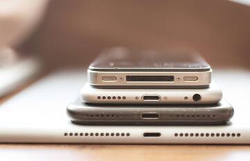 Mehrere iPhones und ein iPad liegen übereinander