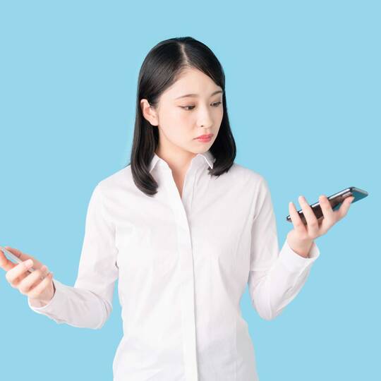 Frau hält in beiden Händen ein Smartphone
