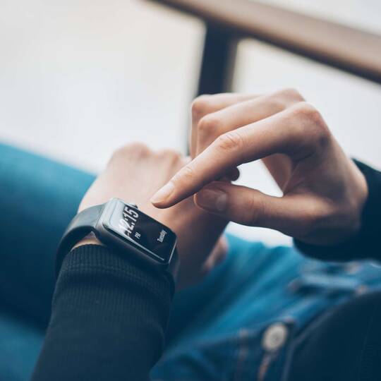 Person taps smartwatch on wrist